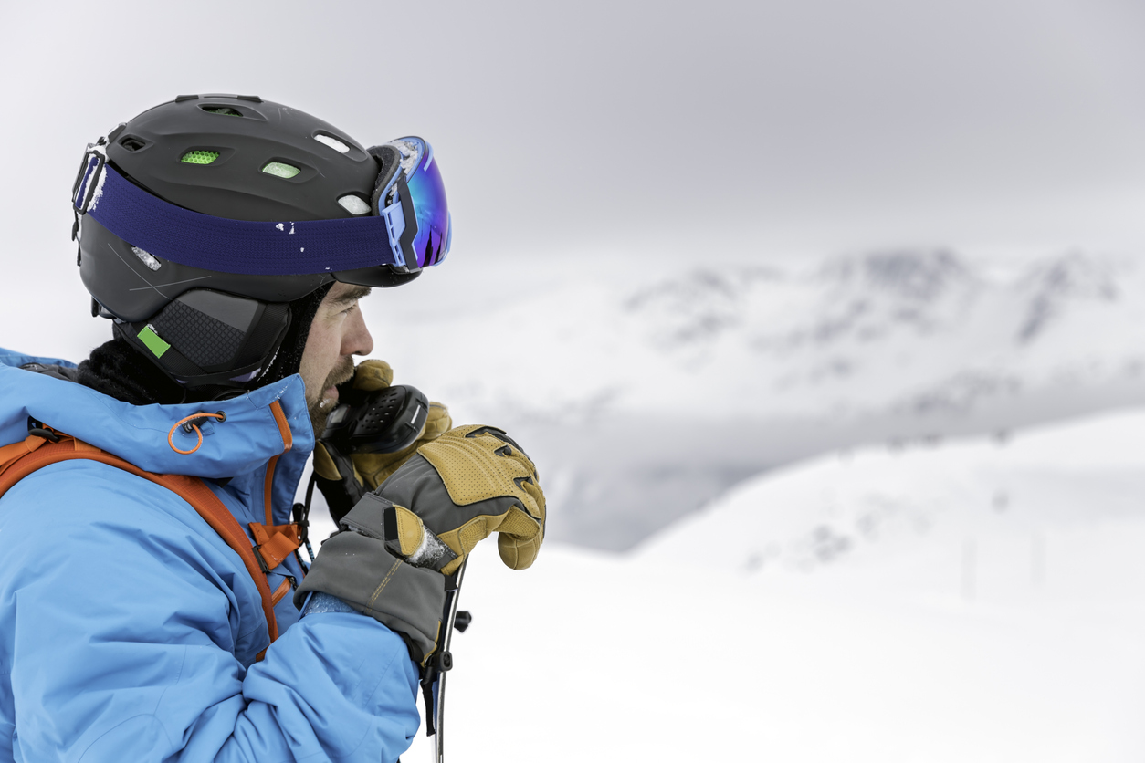 Skier Snowboarder Using Walkie Talkie in Backcountry Area